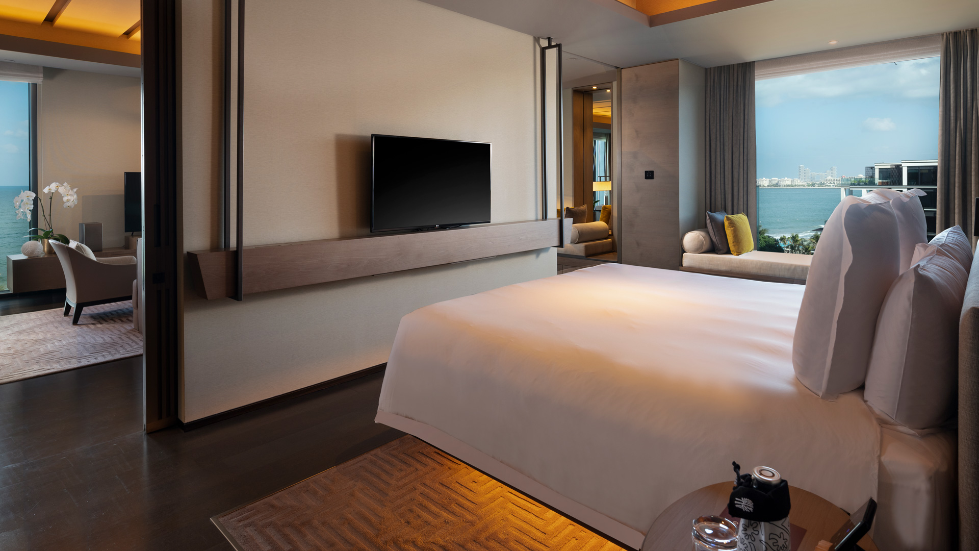 Luxurious harmony oceanview Banyan Tree Dubai master suite with bed, sea view, elegant décor, and cozy seating area.